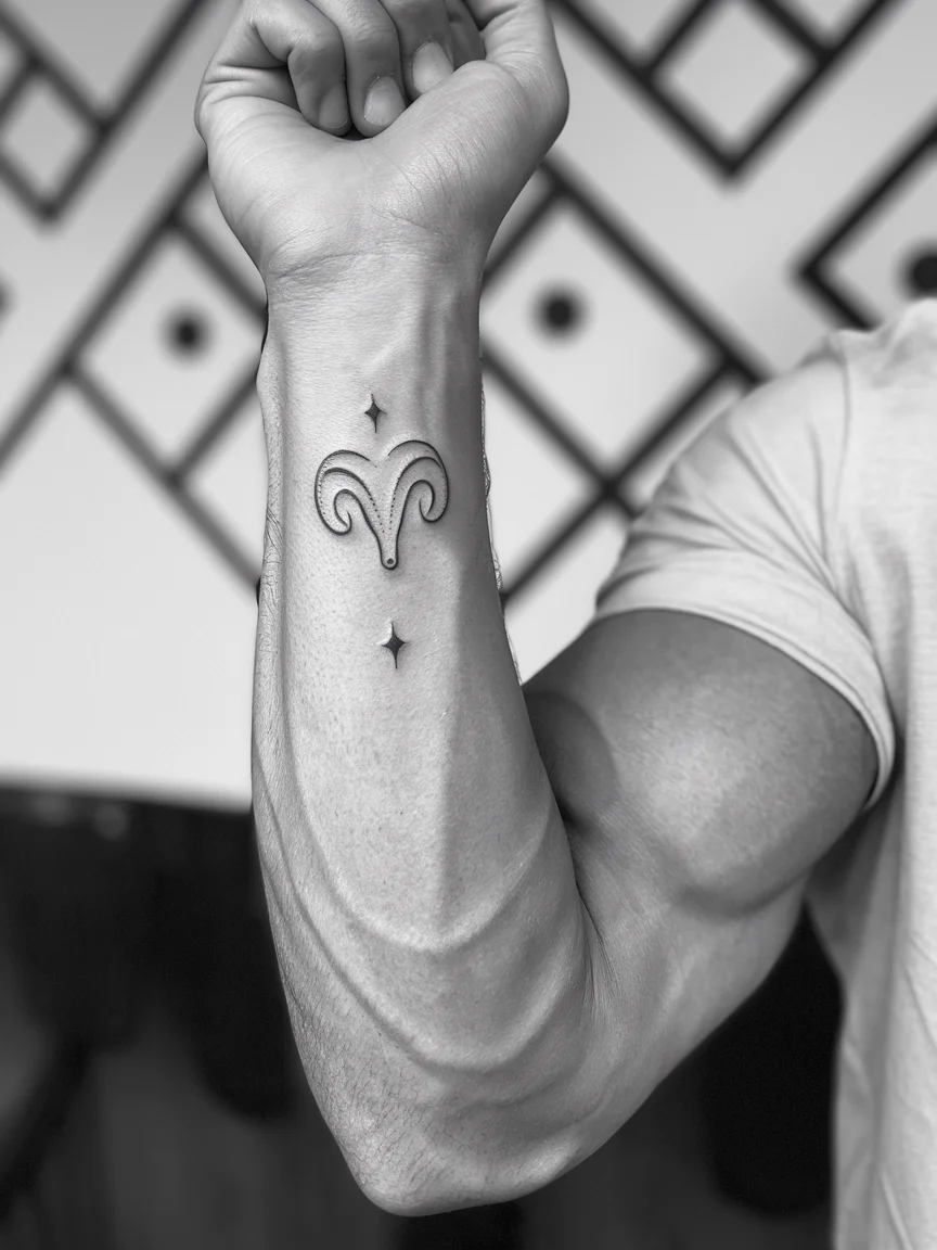 Man's wrist with minimalist zodiac symbol stick and poke tattoo