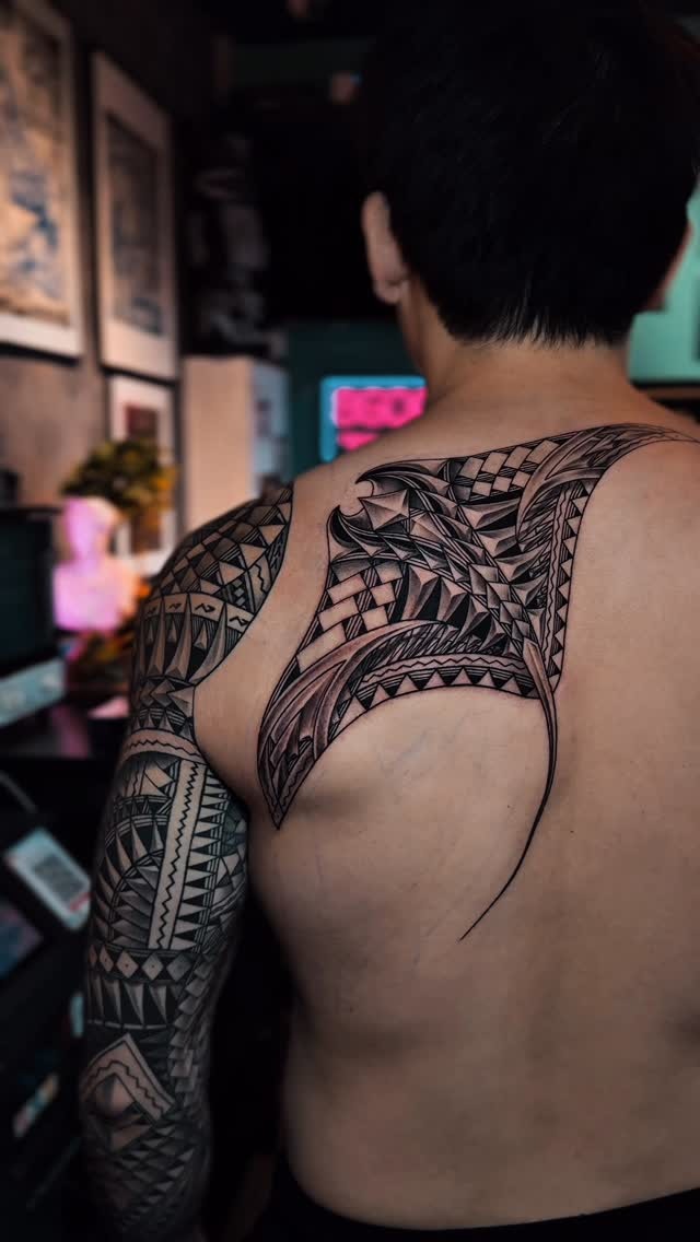 Intricate neo-tribal back and sleeve tattoo