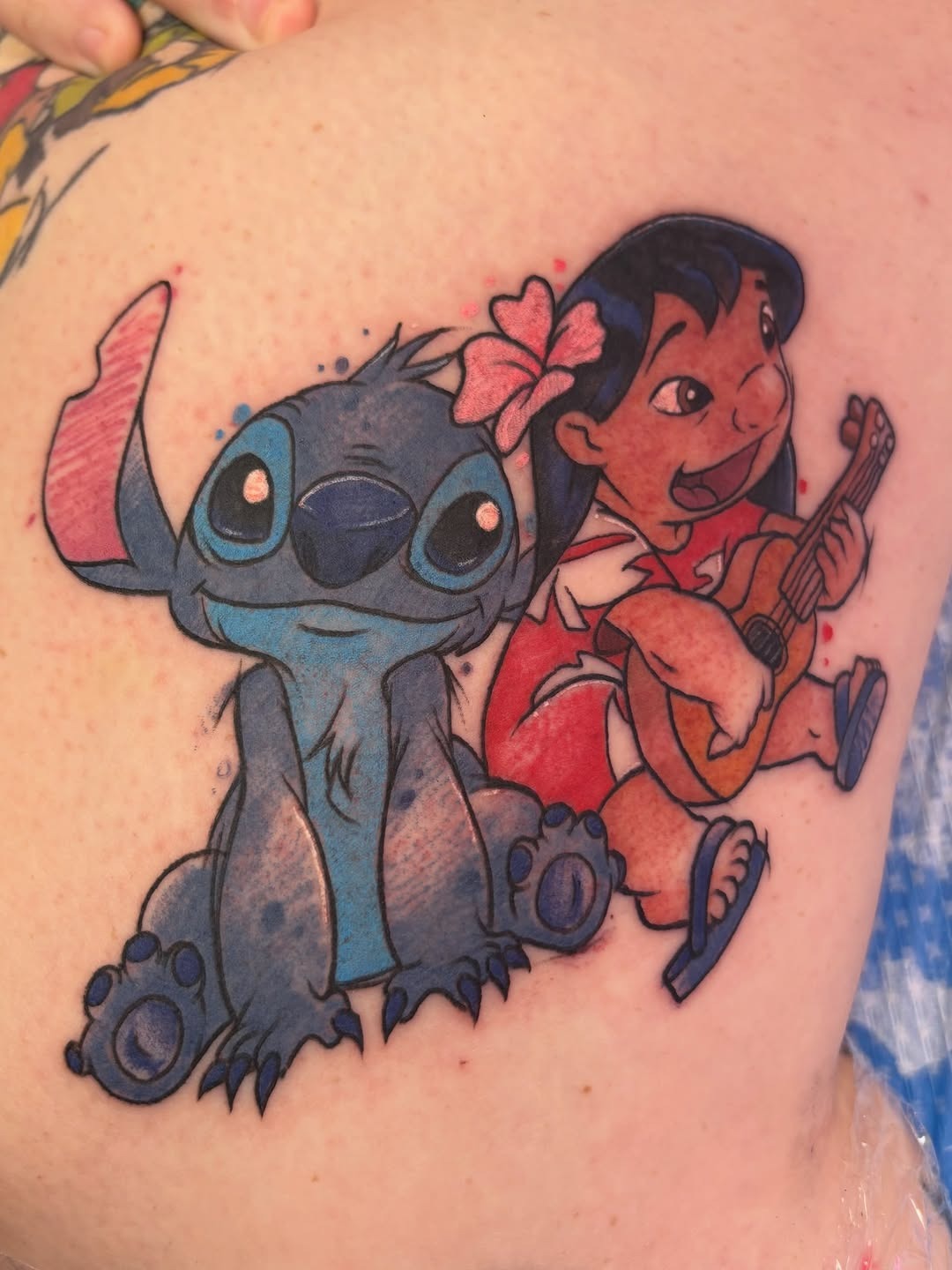 Colorful Lilo and Stitch duo tattoo