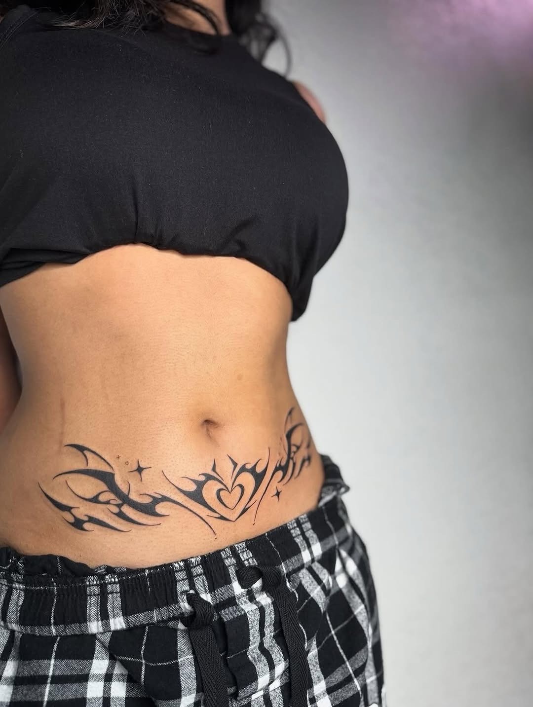 Charming Neo-Tribal Lower Back Tattoo