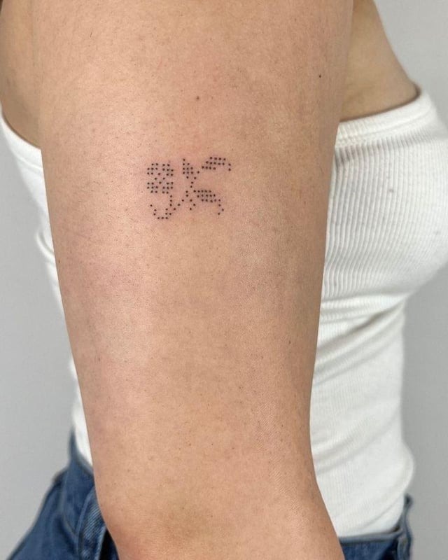 Dainty Micro Cross-Stitch Tattoo