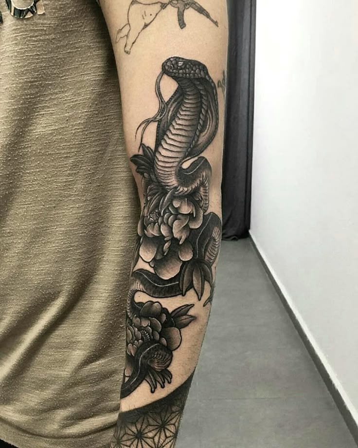 Detailed Floral Cobra Arm Tattoo