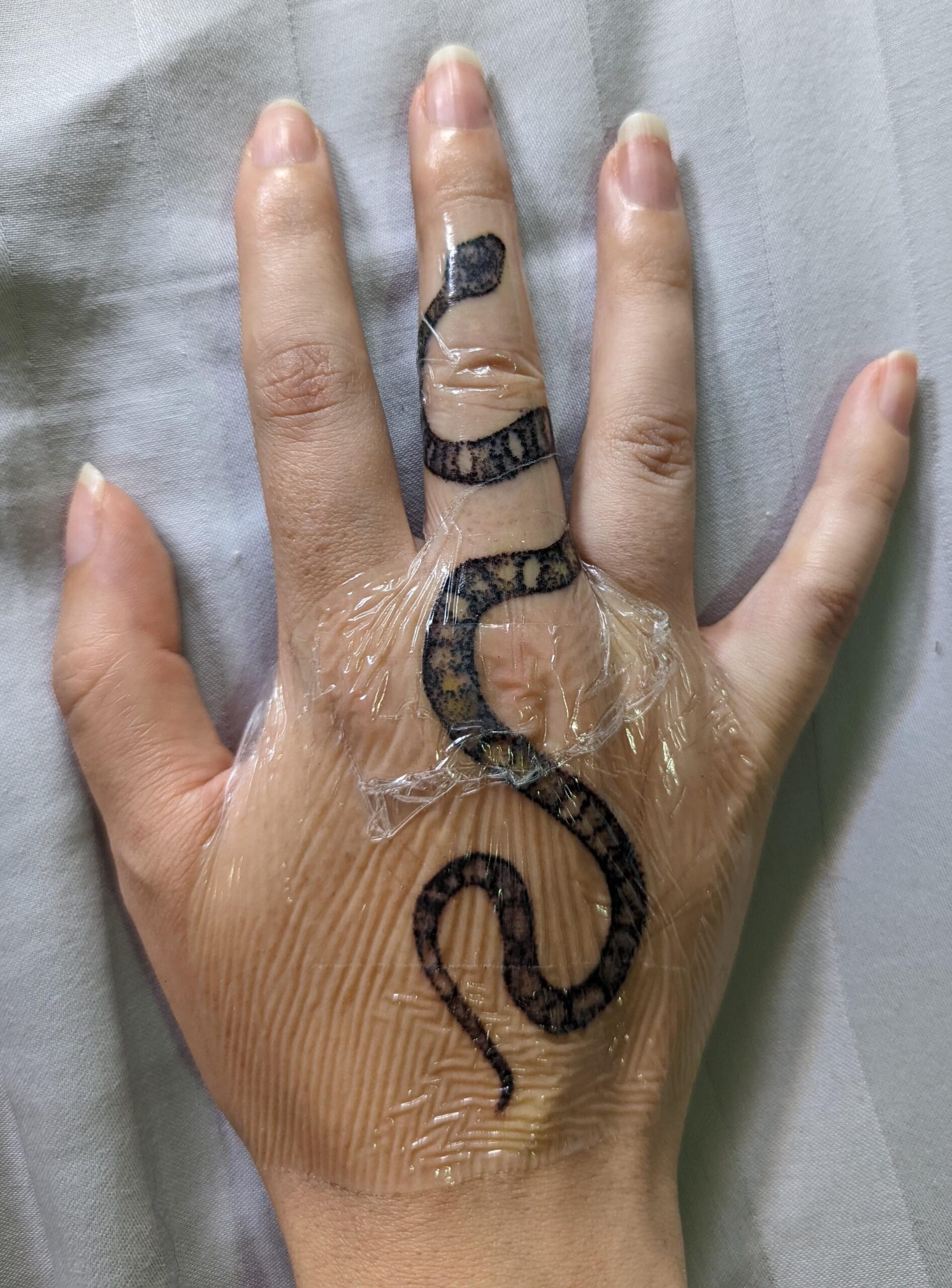 Minimalist Snake Finger Tattoo