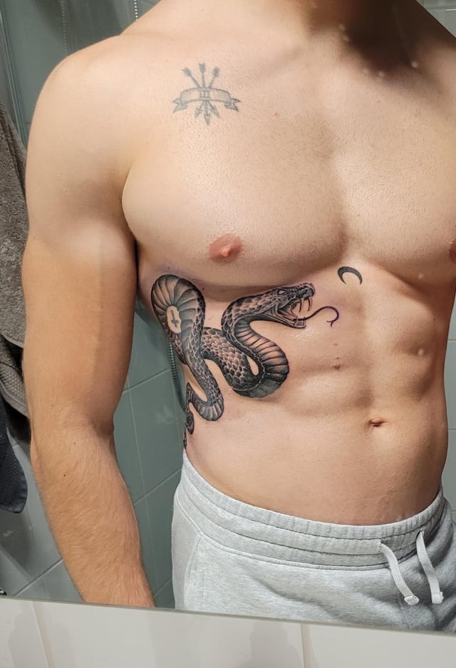 Intricate Rippling Cobra Rib Tattoo