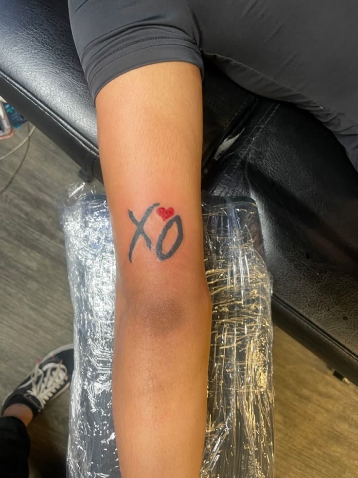 Arm XO Tattoo with a Heart Accent