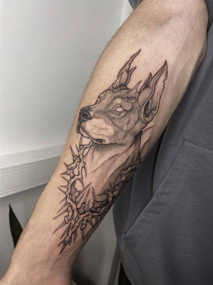 Intricate black and grey Doberman tattoo