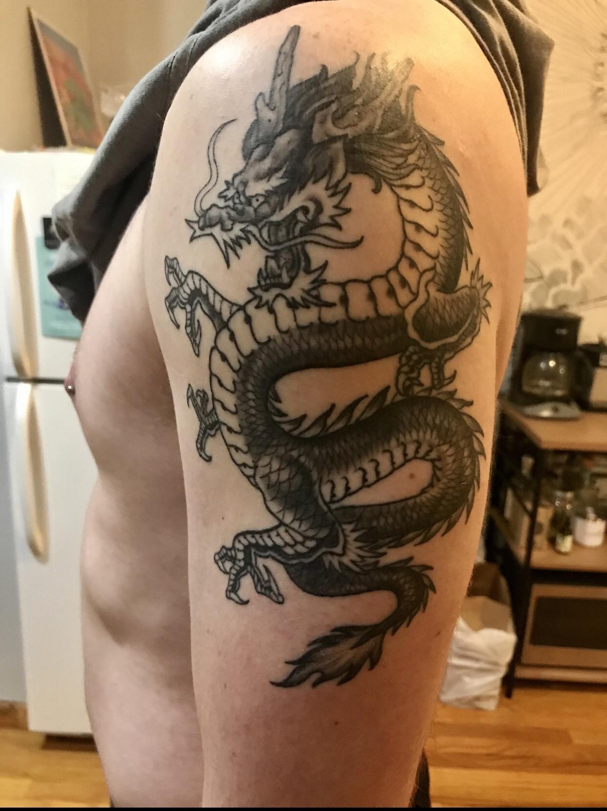 Traditional Style Dragon Upper Arm Tattoo