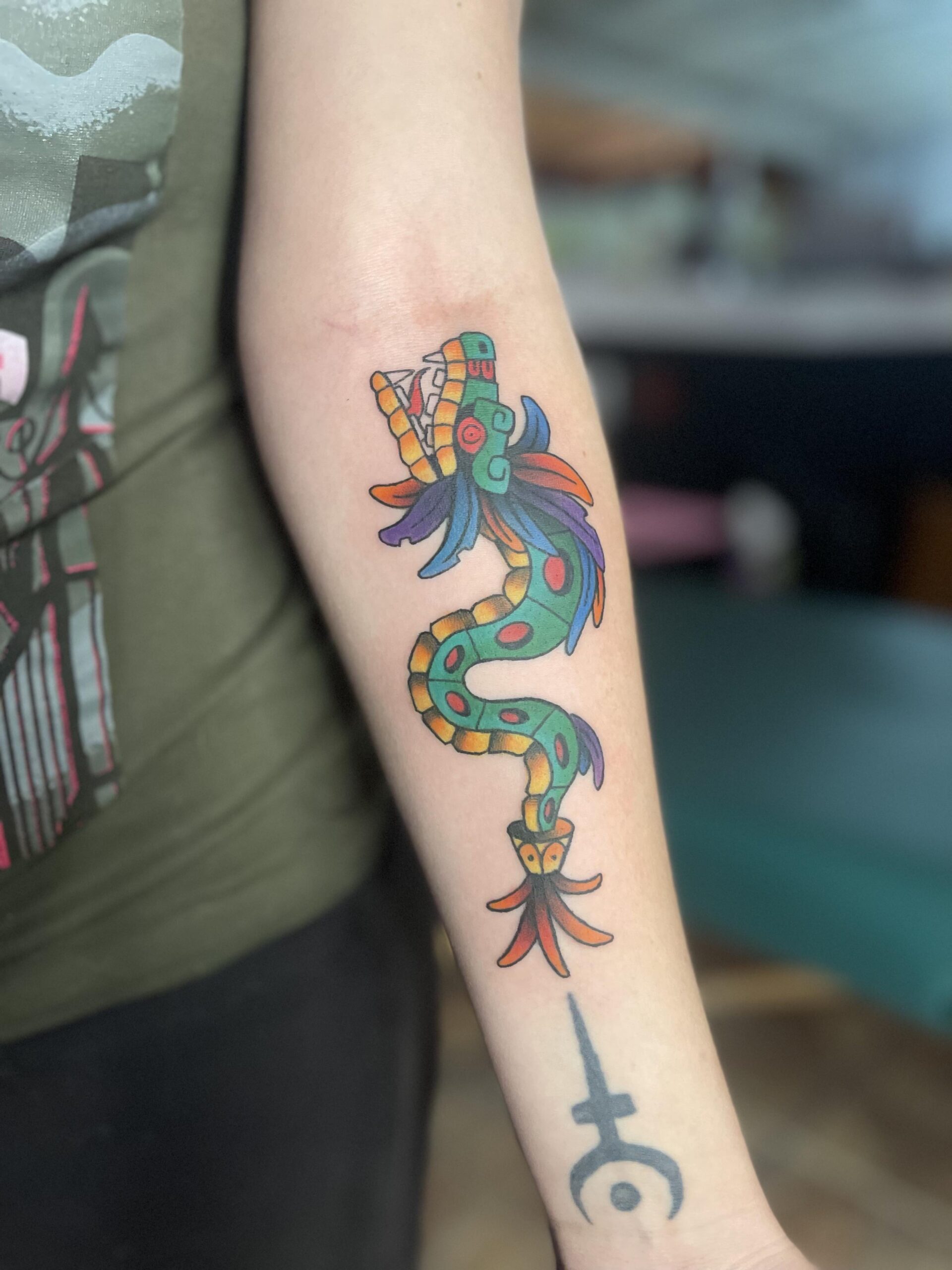 Vibrant Serpent God Forearm Tattoo