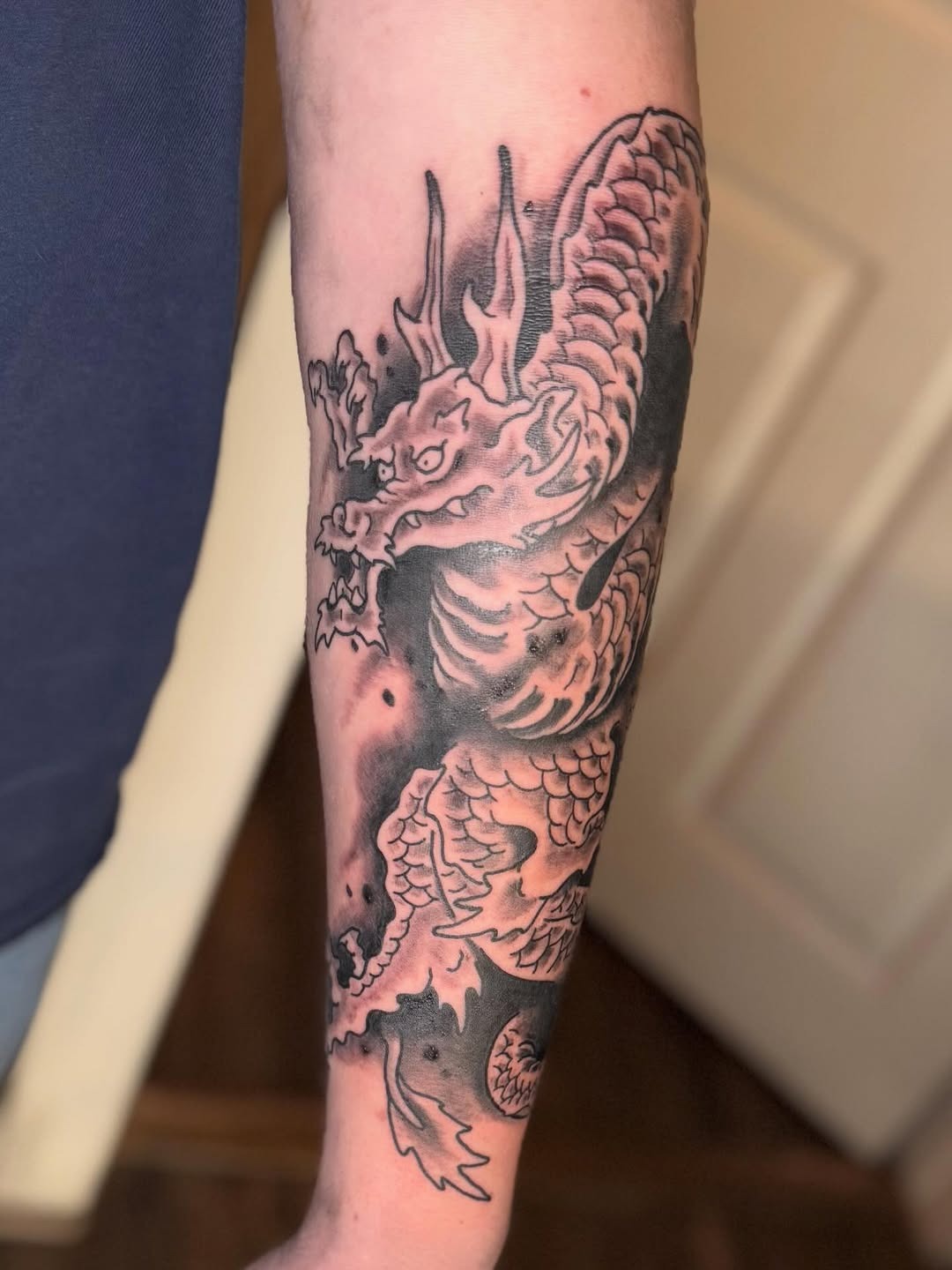 Classic Black and Grey Dragon Forearm Tattoo