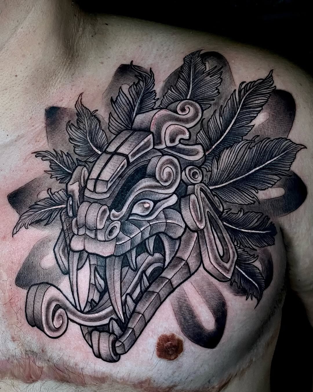 Bold Illustrative Quetzalcoatl Chest Tattoo