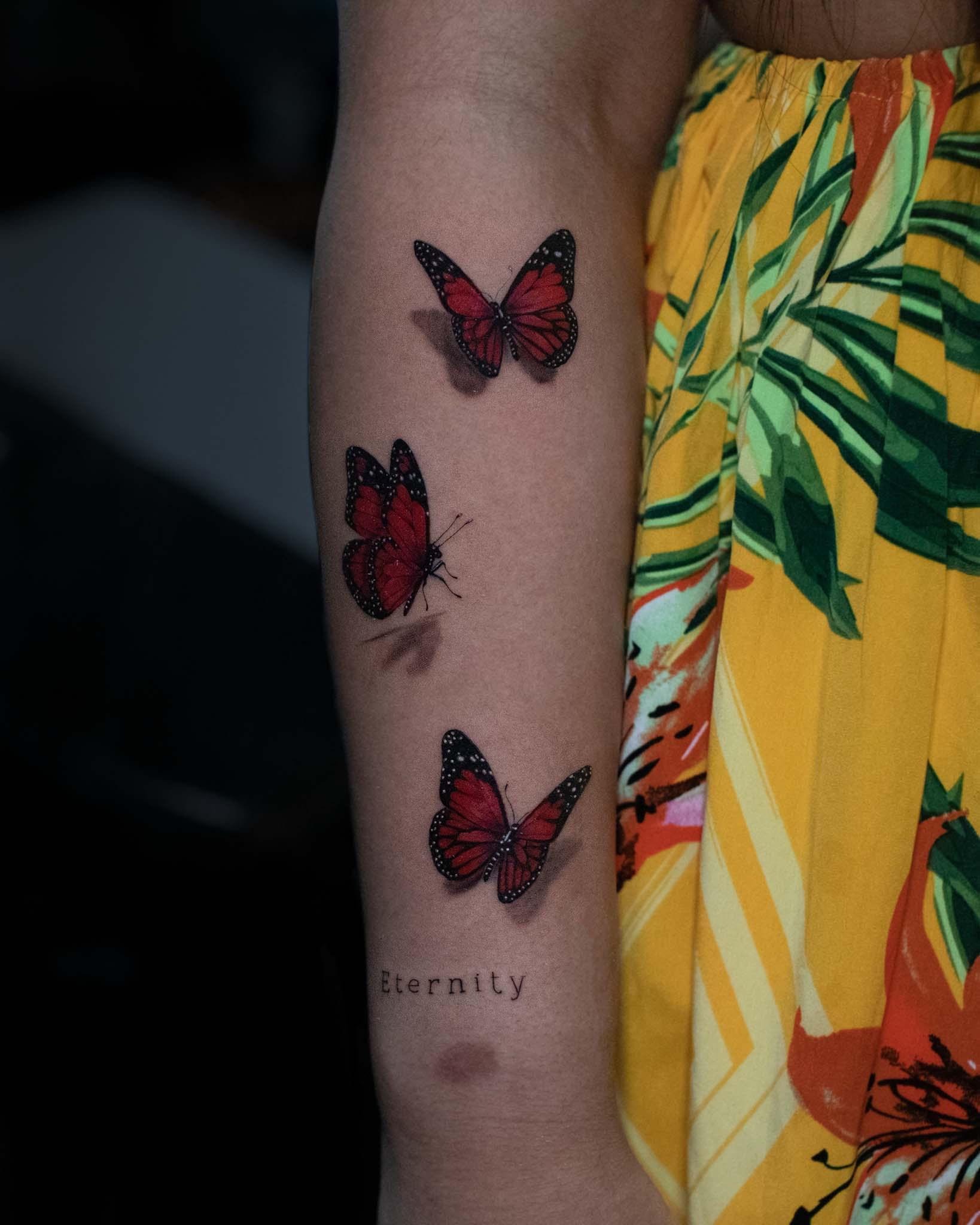 Whimsical Trio of Red Butterfly Tattoos