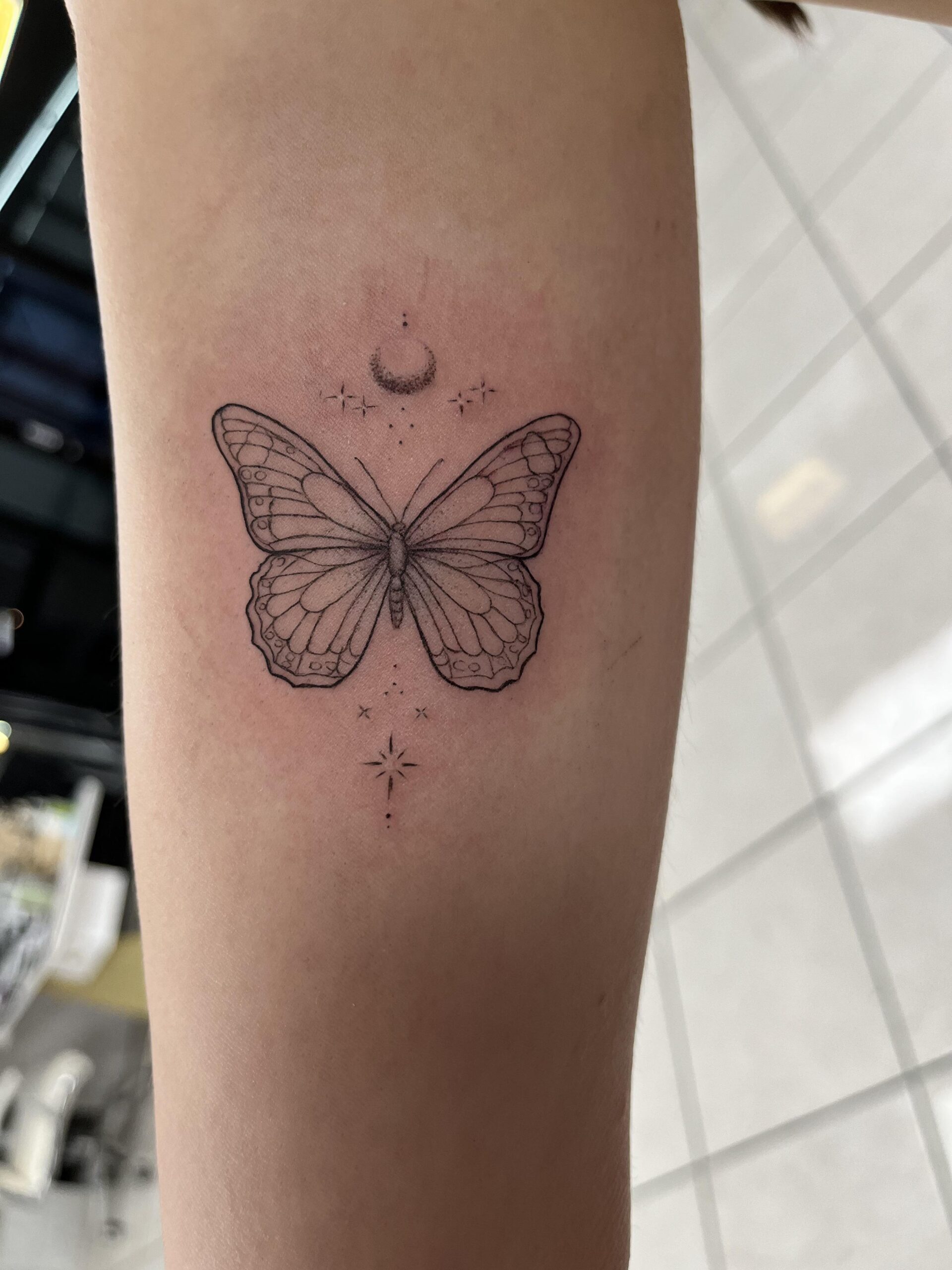 Delicate Fine-Line Butterfly Tattoo