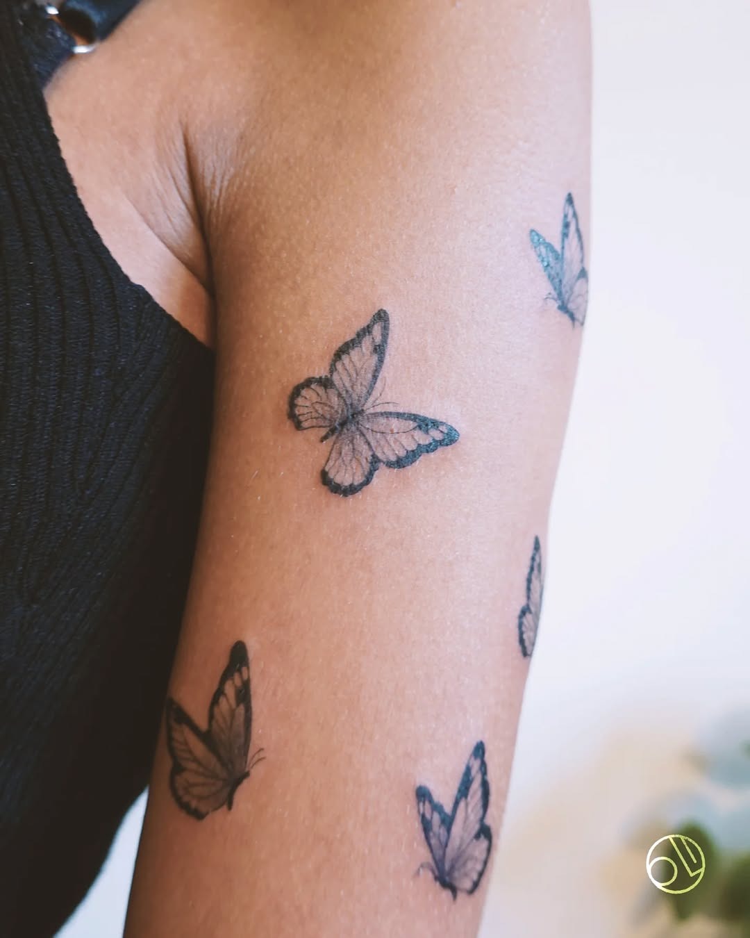 Whimsical butterfly swarm tattoo