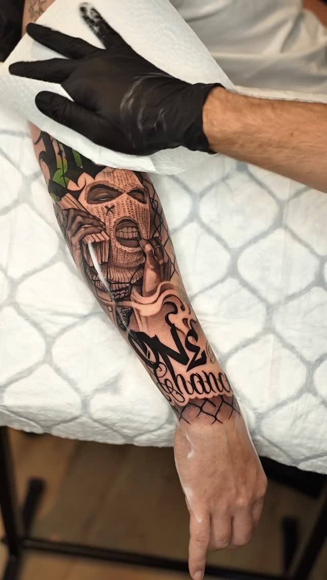 Skull Mask Forearm Tattoo Detail