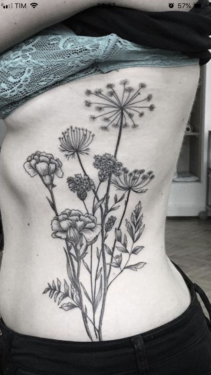 Delicate Wildflower Ribcage Tattoo