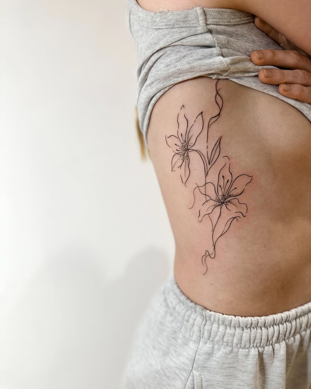 Minimalist Fine-Line Rib Tattoos