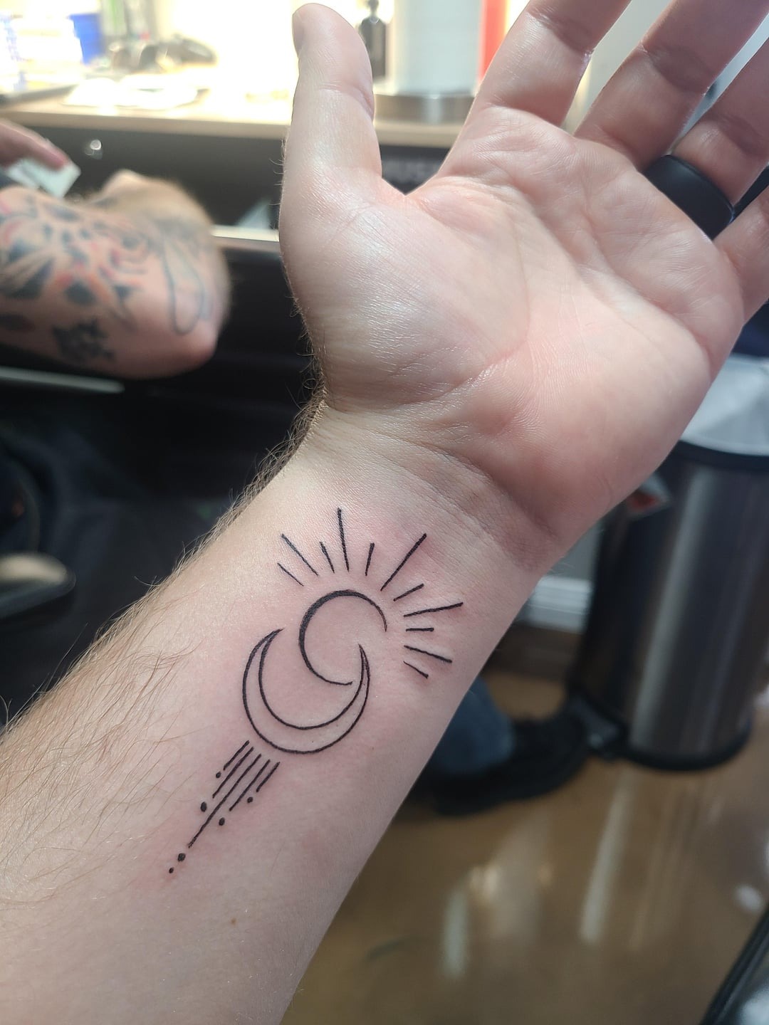 Minimalist Sun and Moon Wrist Tattoo
