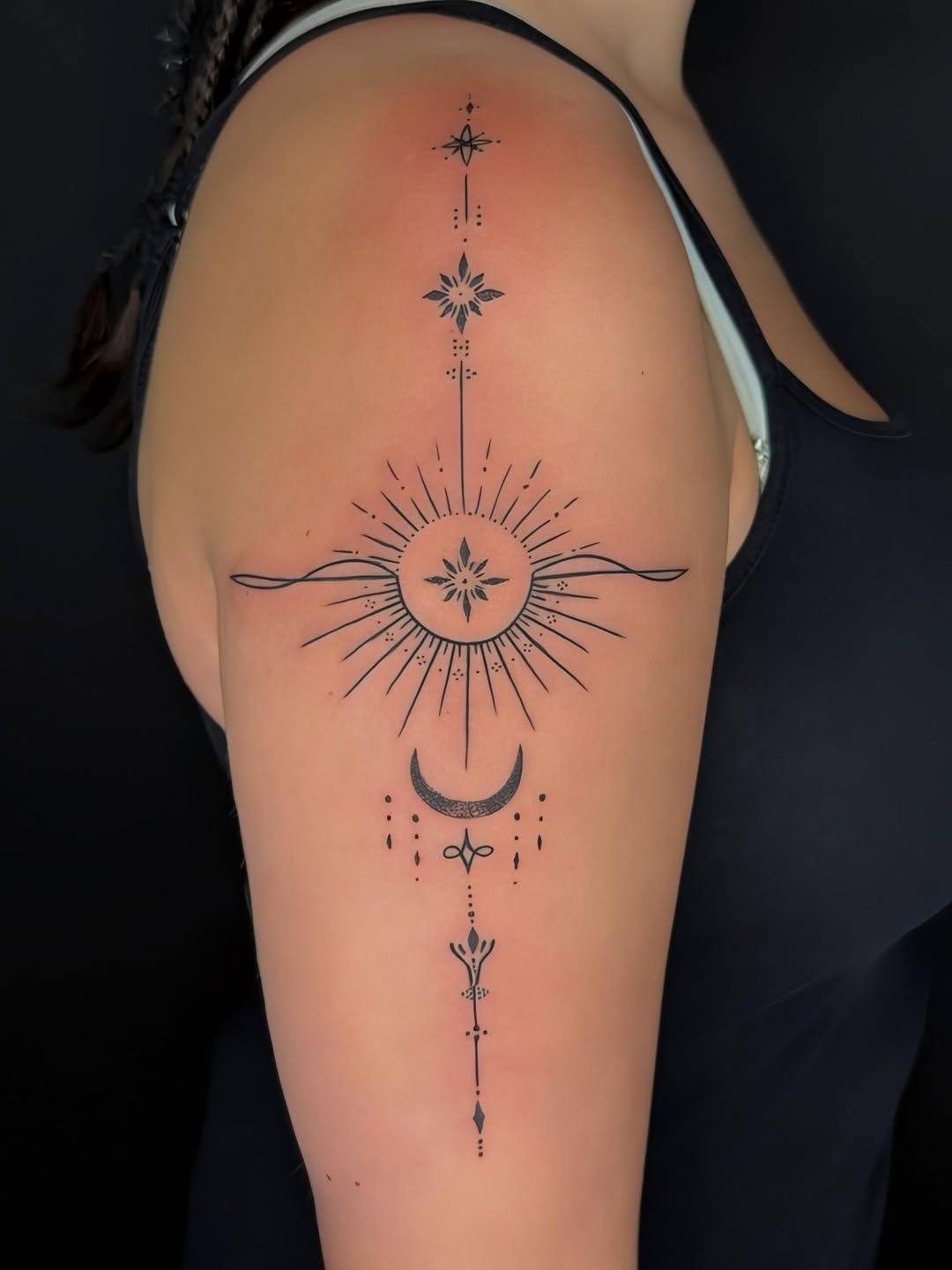 Delicate vertical sun line-work tattoo