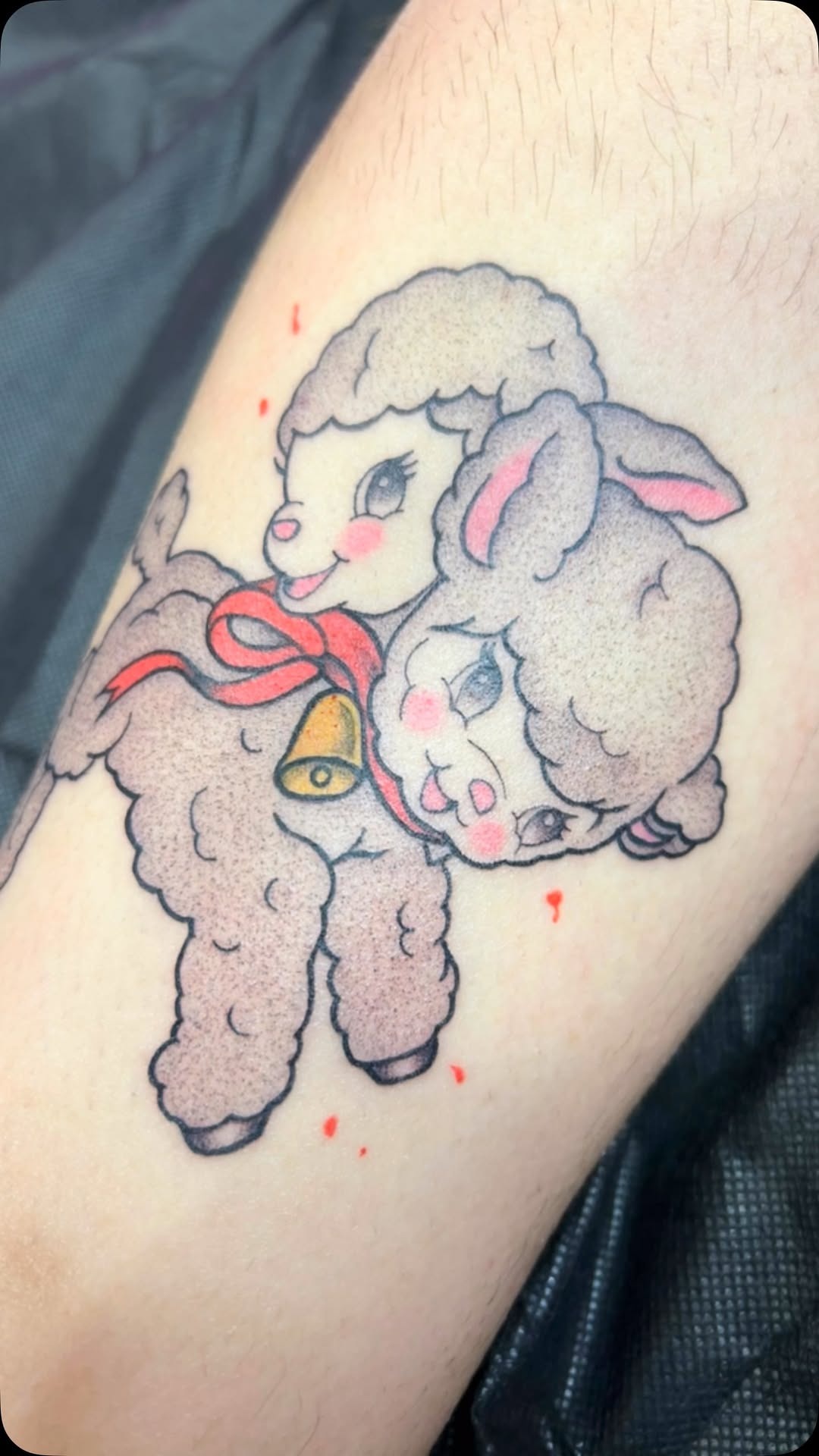 Whimsical pair of lamb tattoos