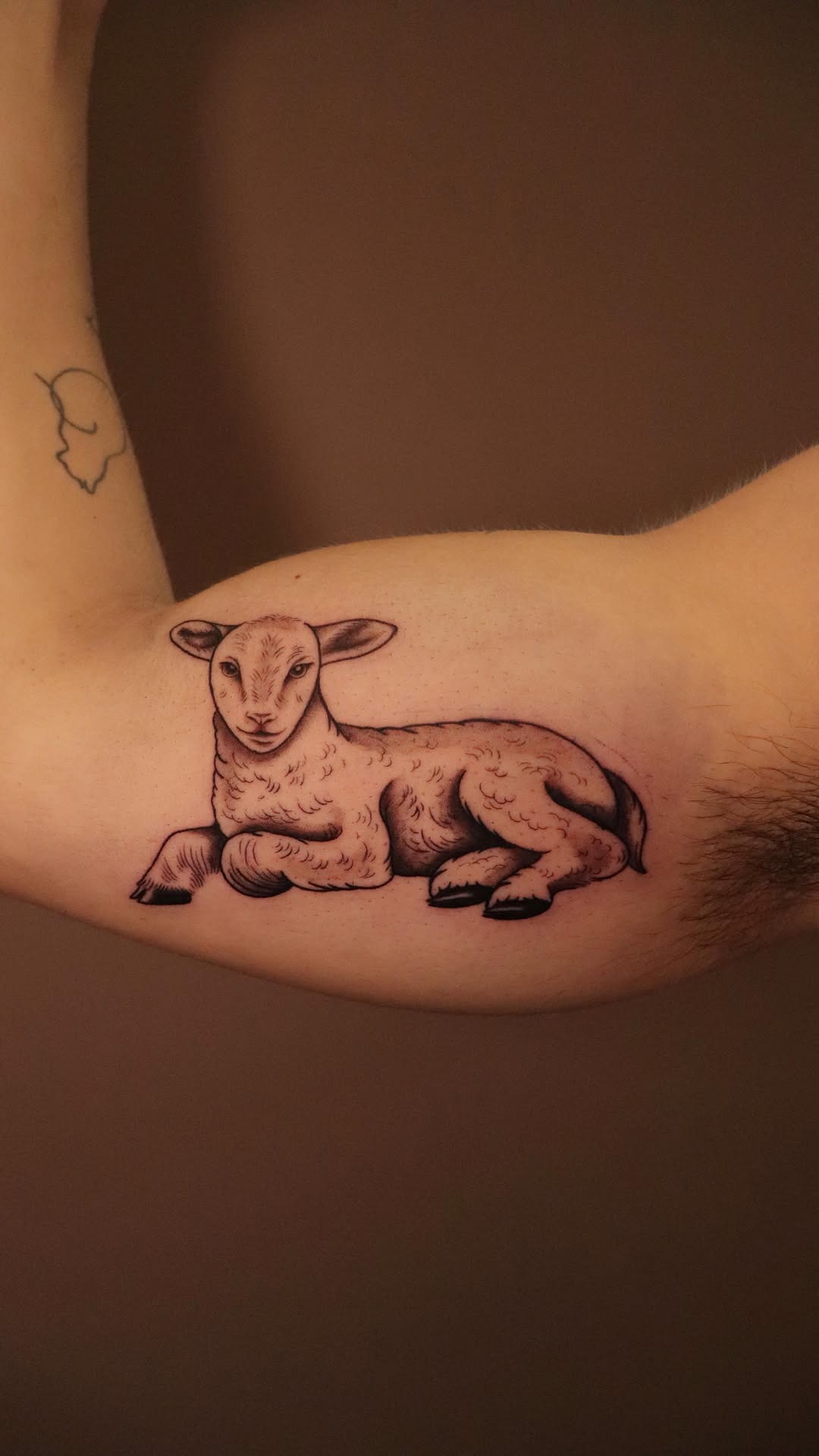 Realistic detailed lamb arm tattoo