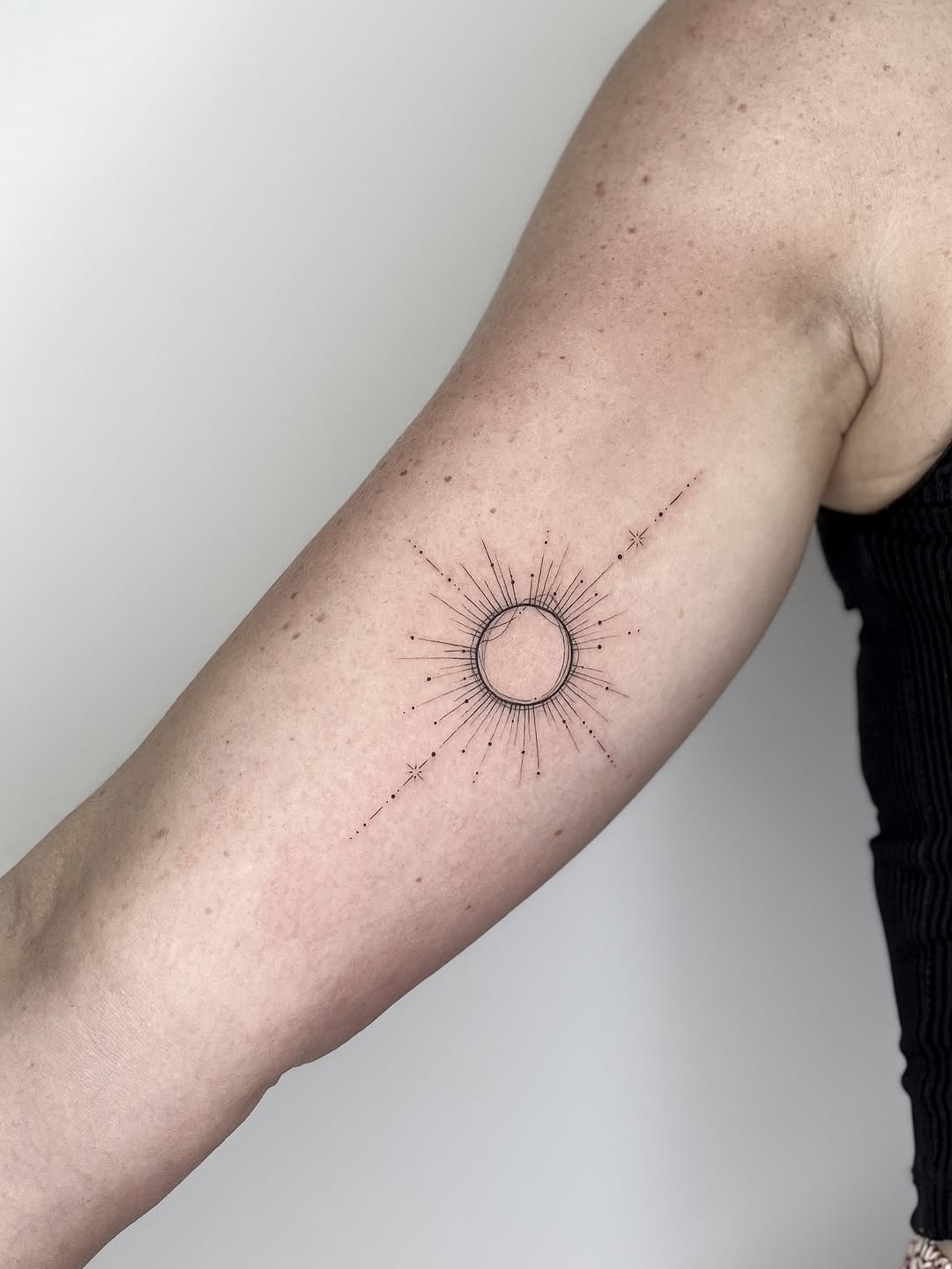 Minimalist geometric sun tattoo