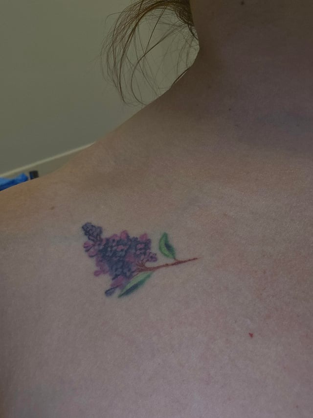 Minimalist lilac clavicle tattoo