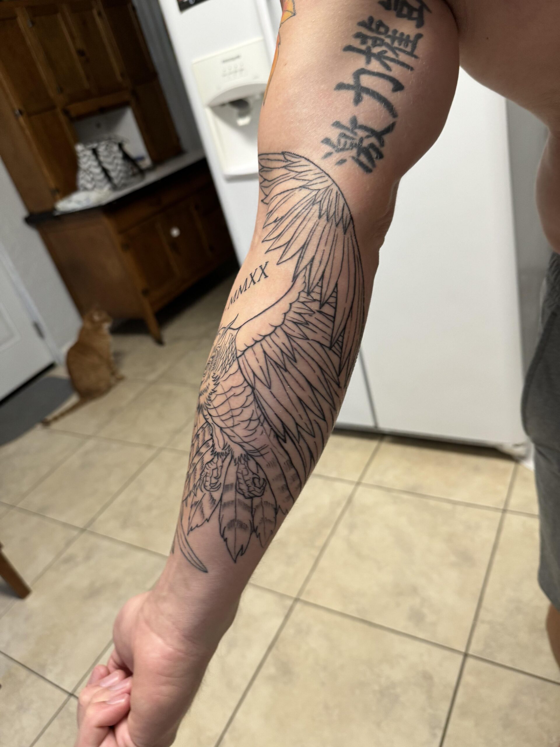 Detailed Forearm Wing Tattoo