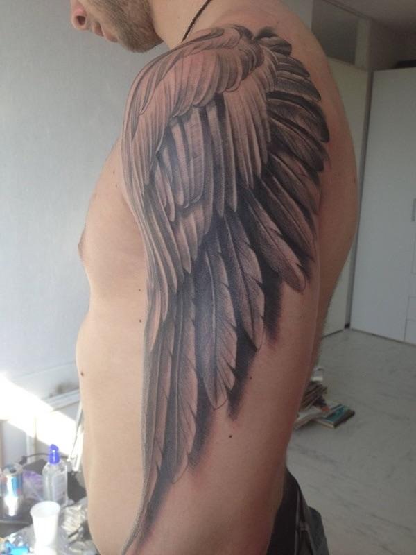 Classic detailed wing shoulder tattoo for men