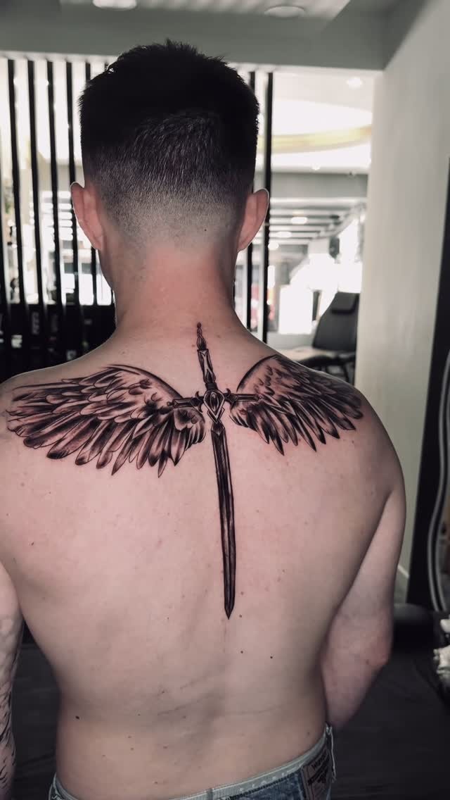 Striking Back Wing and Sword Tattoo