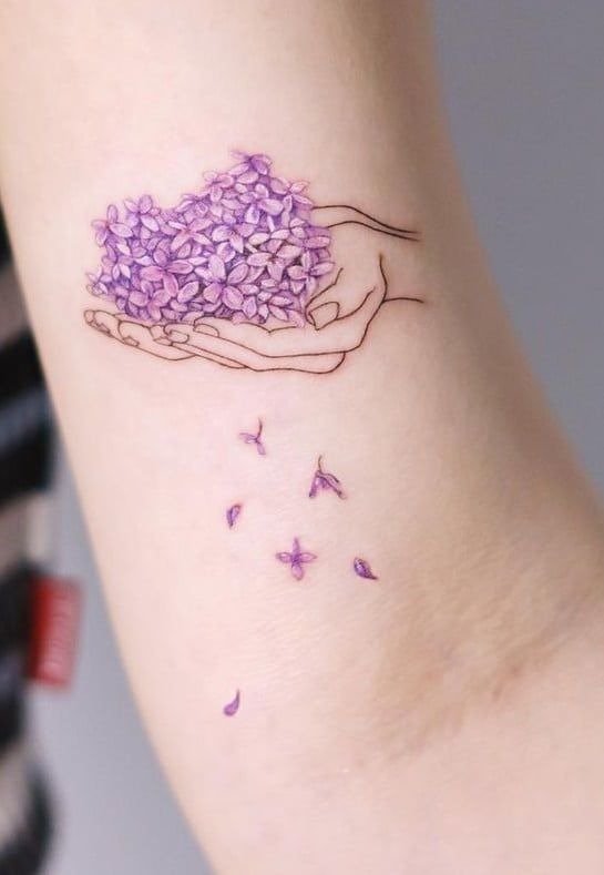 Minimalist lilac floral hand tattoo