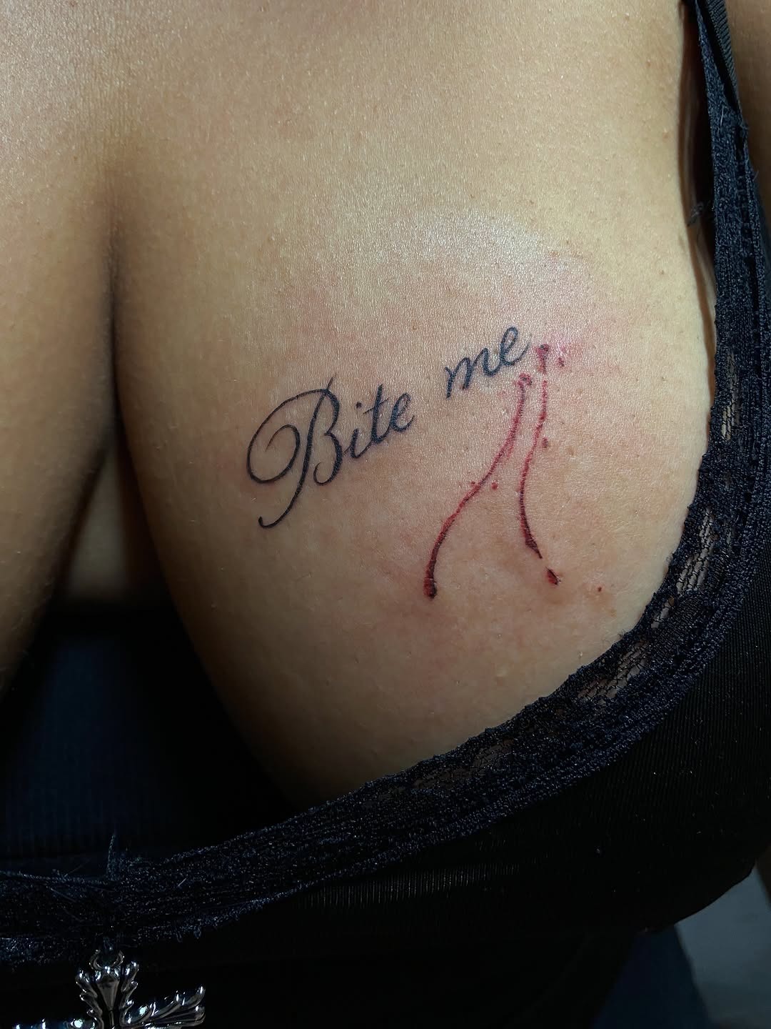 Edgy 'Bite Me' script tattoo with dripping detail
