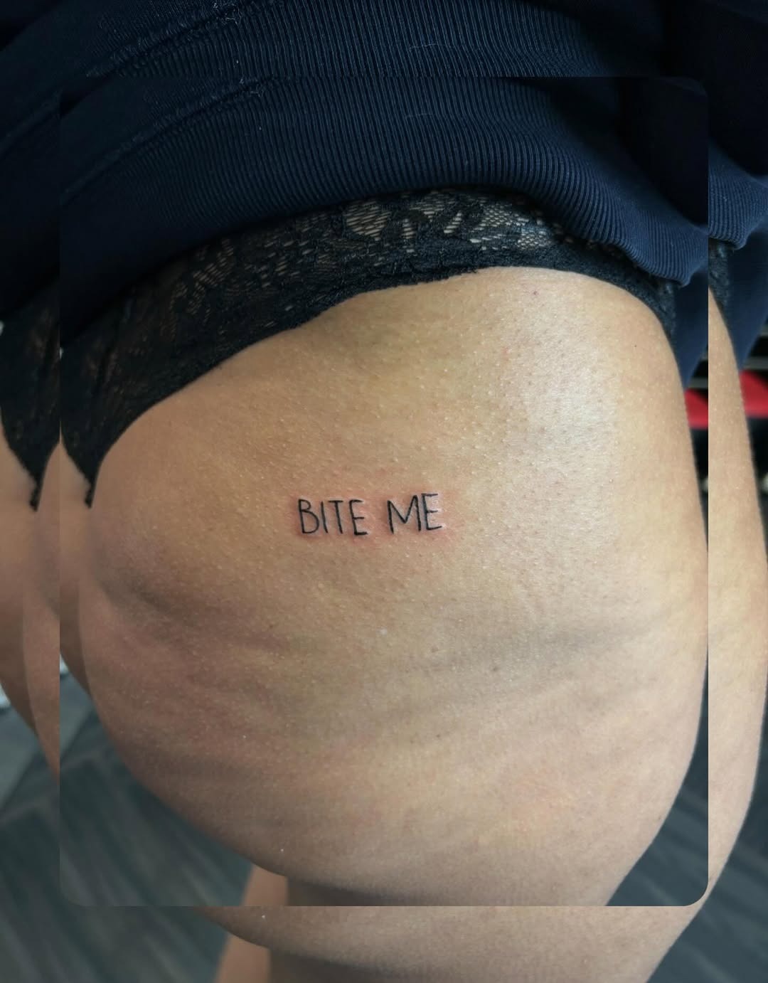 Bold font 'Bite Me' hip tattoo