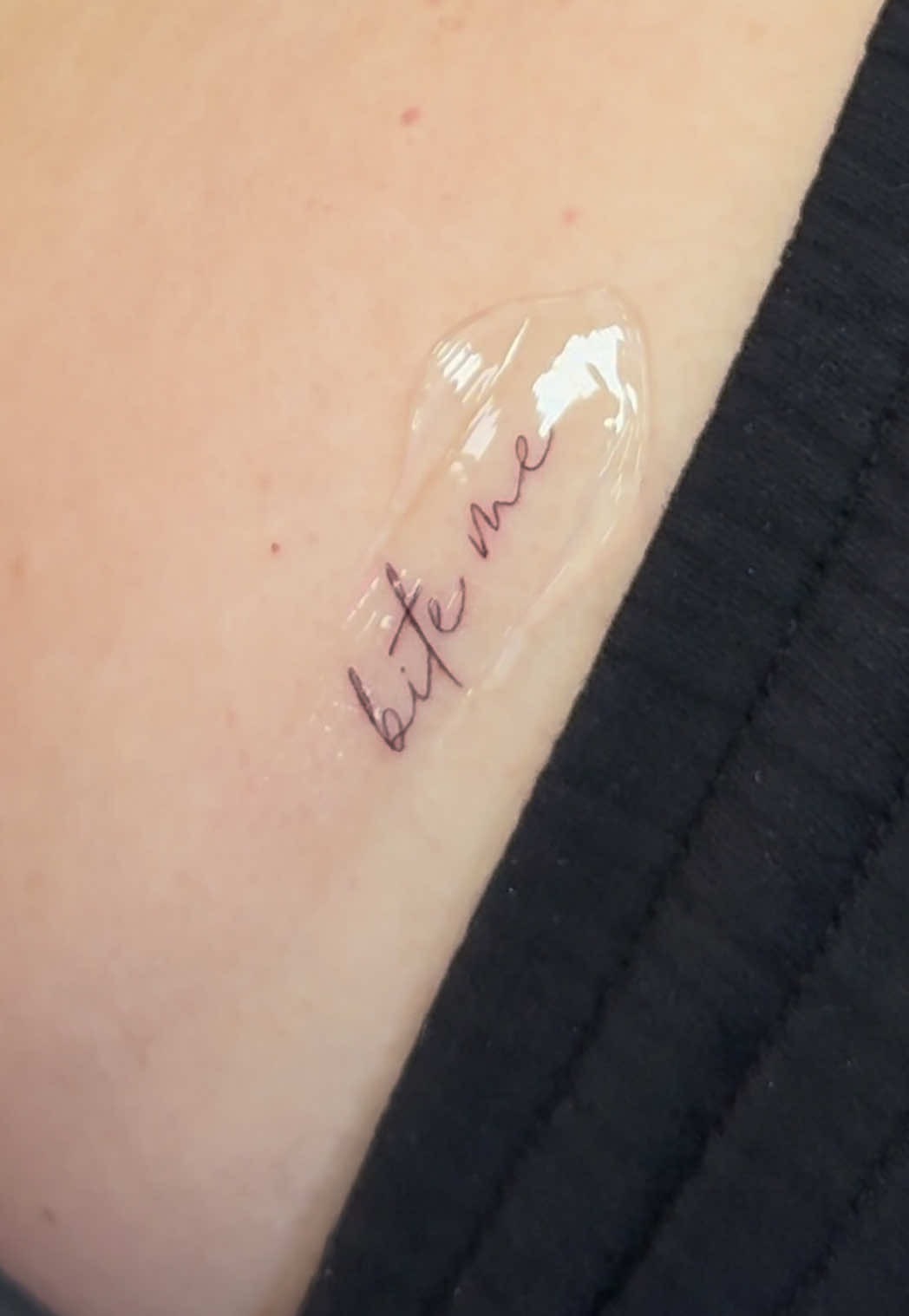 Dainty 'Bite Me' Script Tattoo