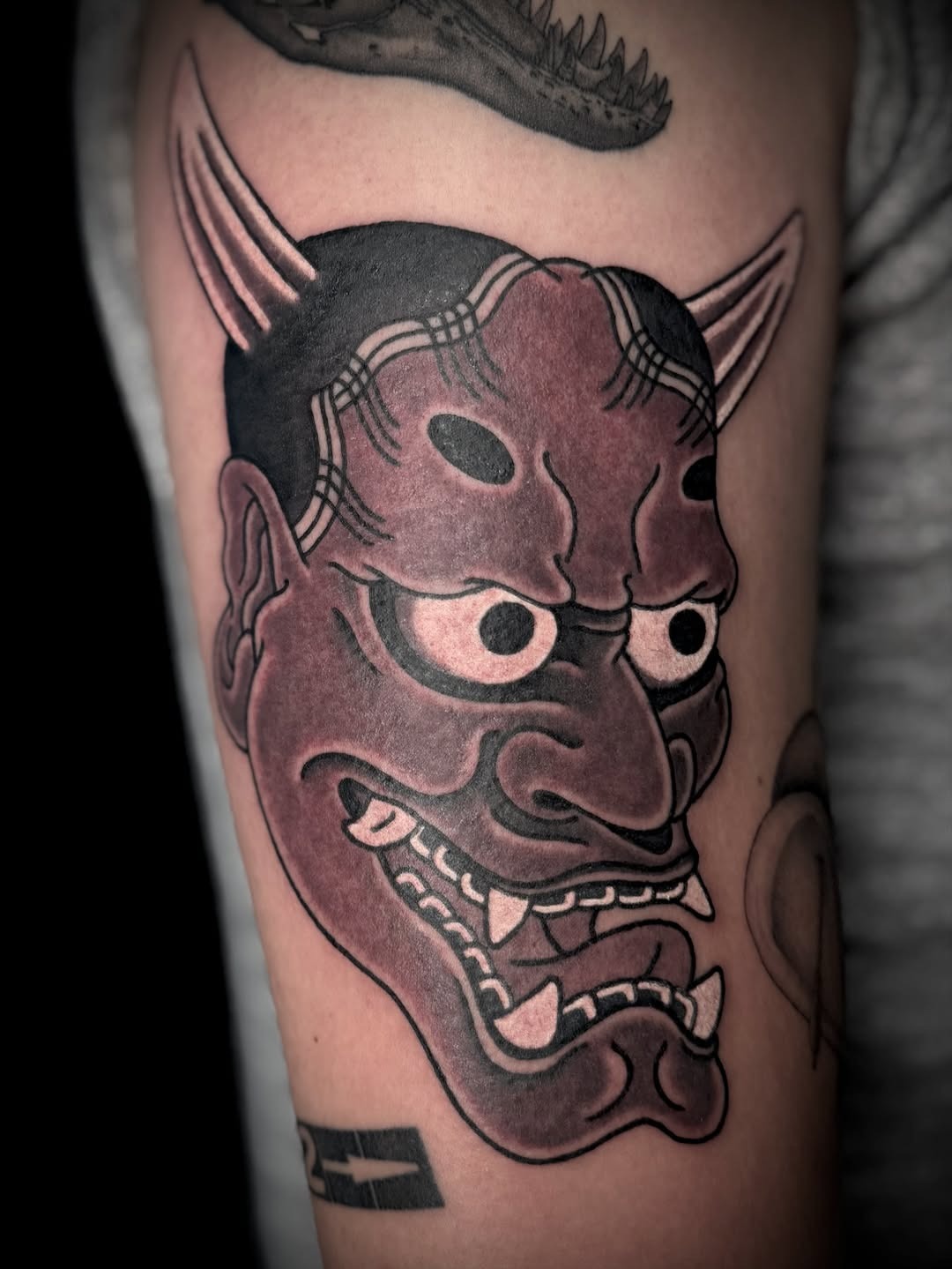 Bold traditional Hannya mask tattoo work