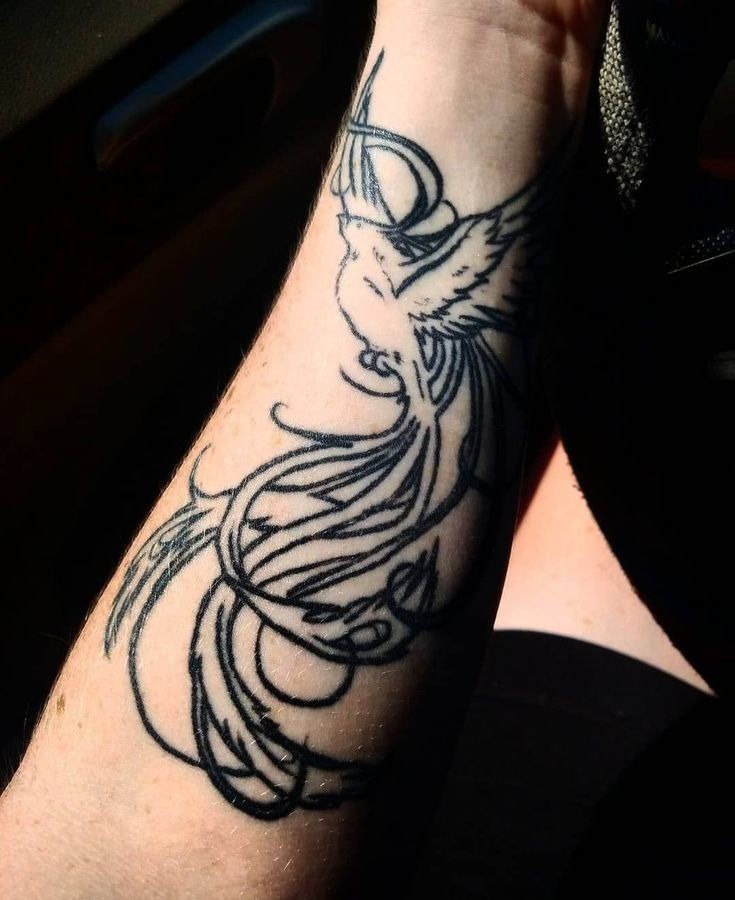 Bold blackwork phoenix arm tattoo