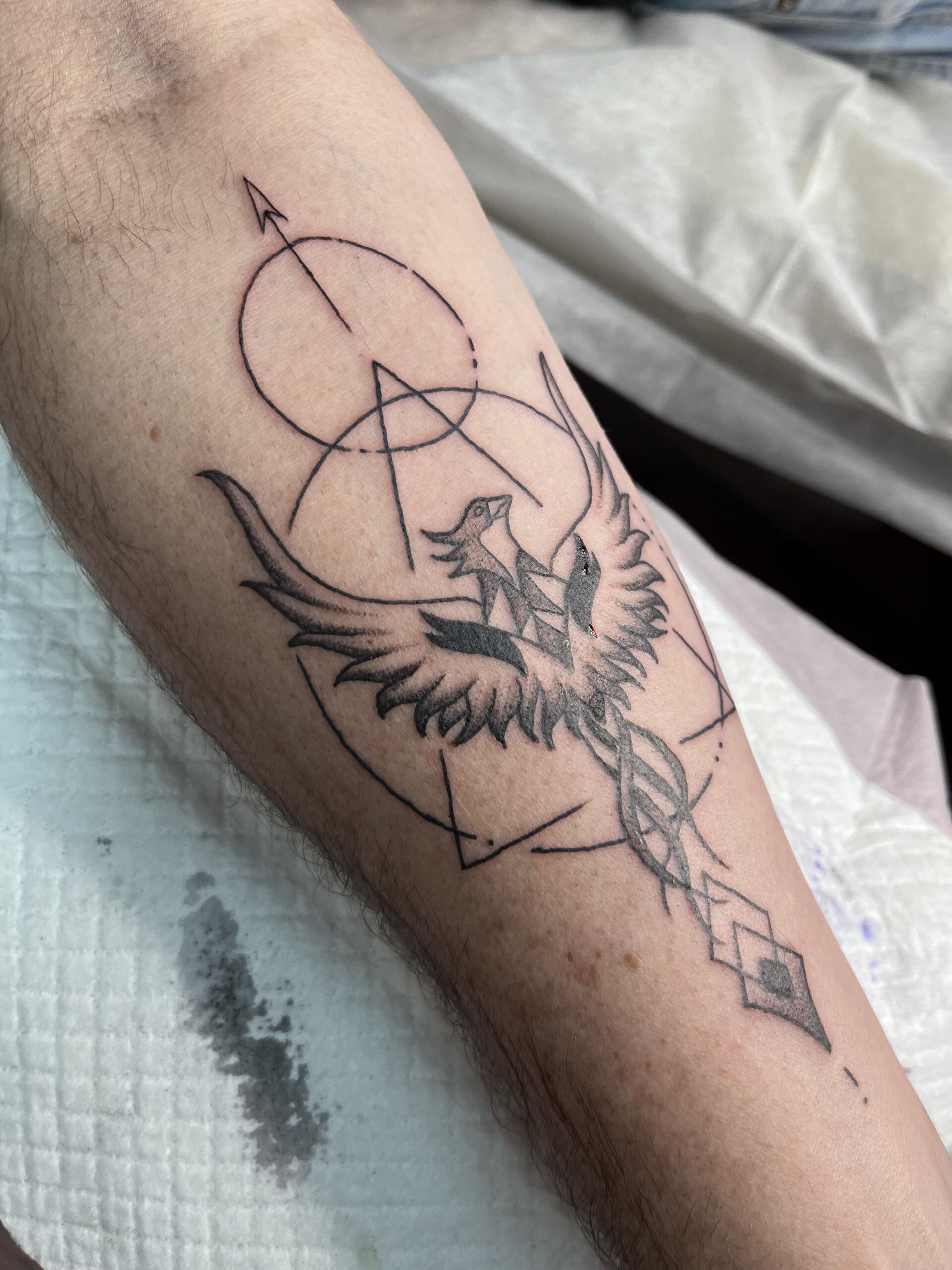 Geometric Phoenix Arm Tattoo