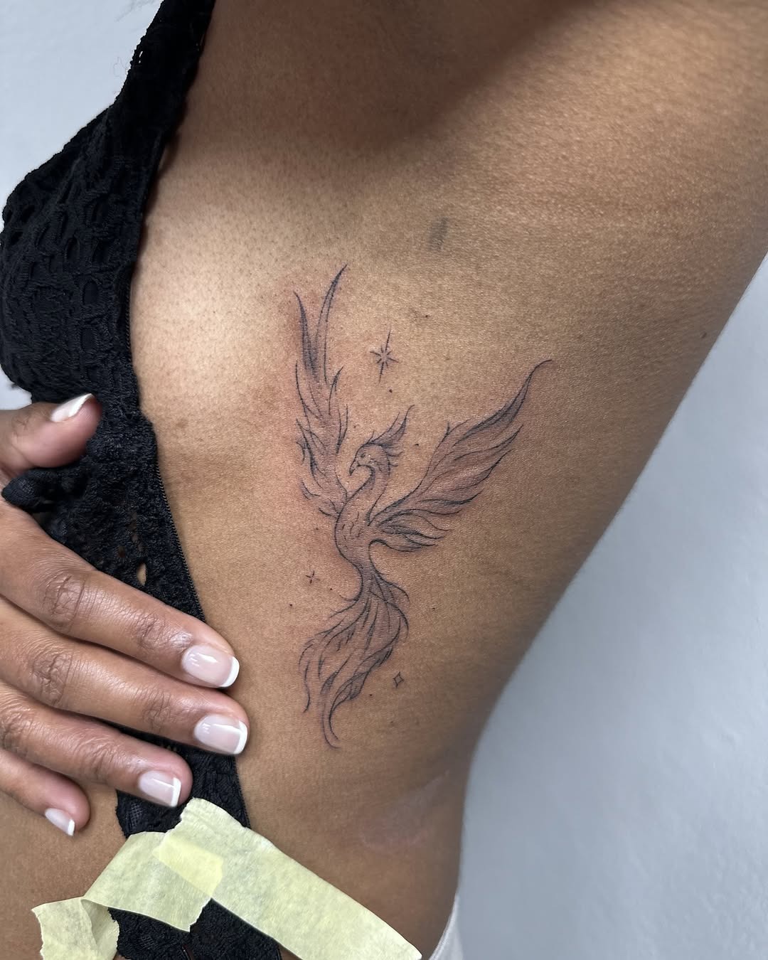Fine Line Phoenix Side Tattoo