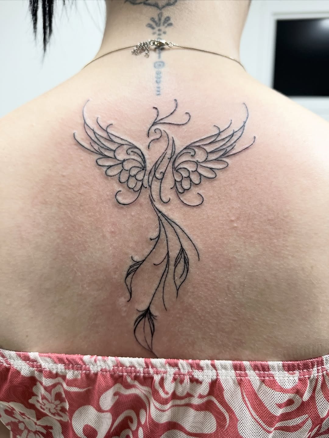 Elegant Fine-Line Back Tattoo