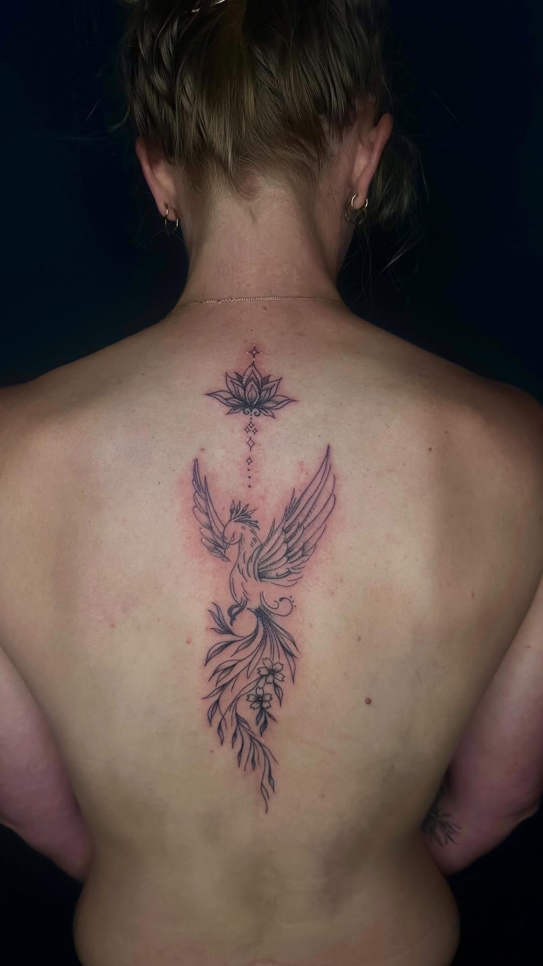 Elegant vertical spine phoenix tattoo