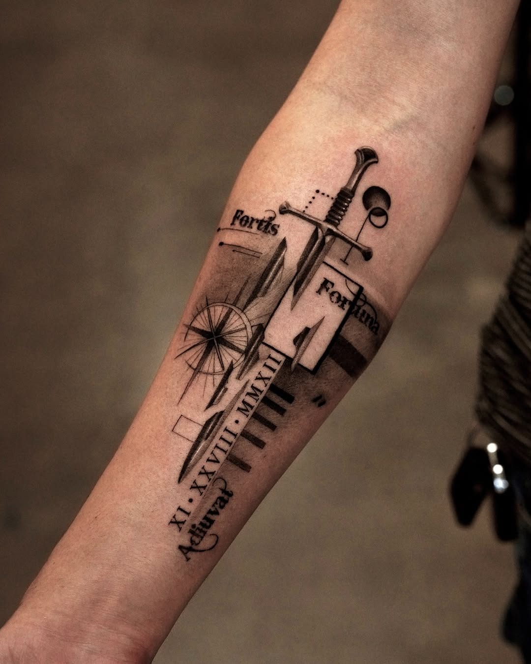 Modern Sword and Script Forearm Tattoo
