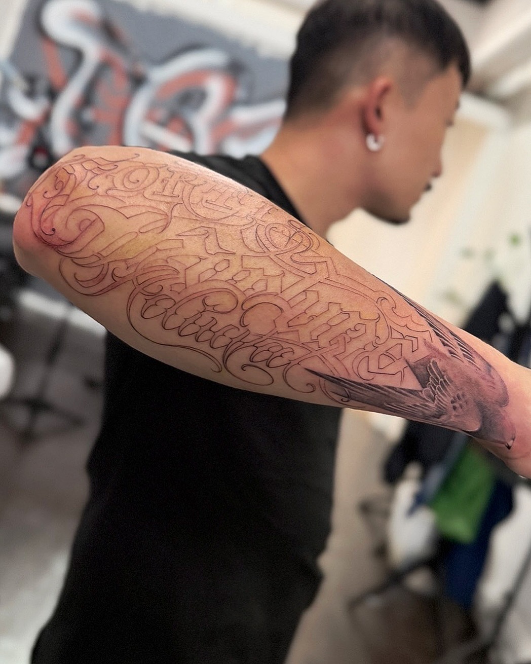 Bold Wrap Around Arm Lettering Tattoo
