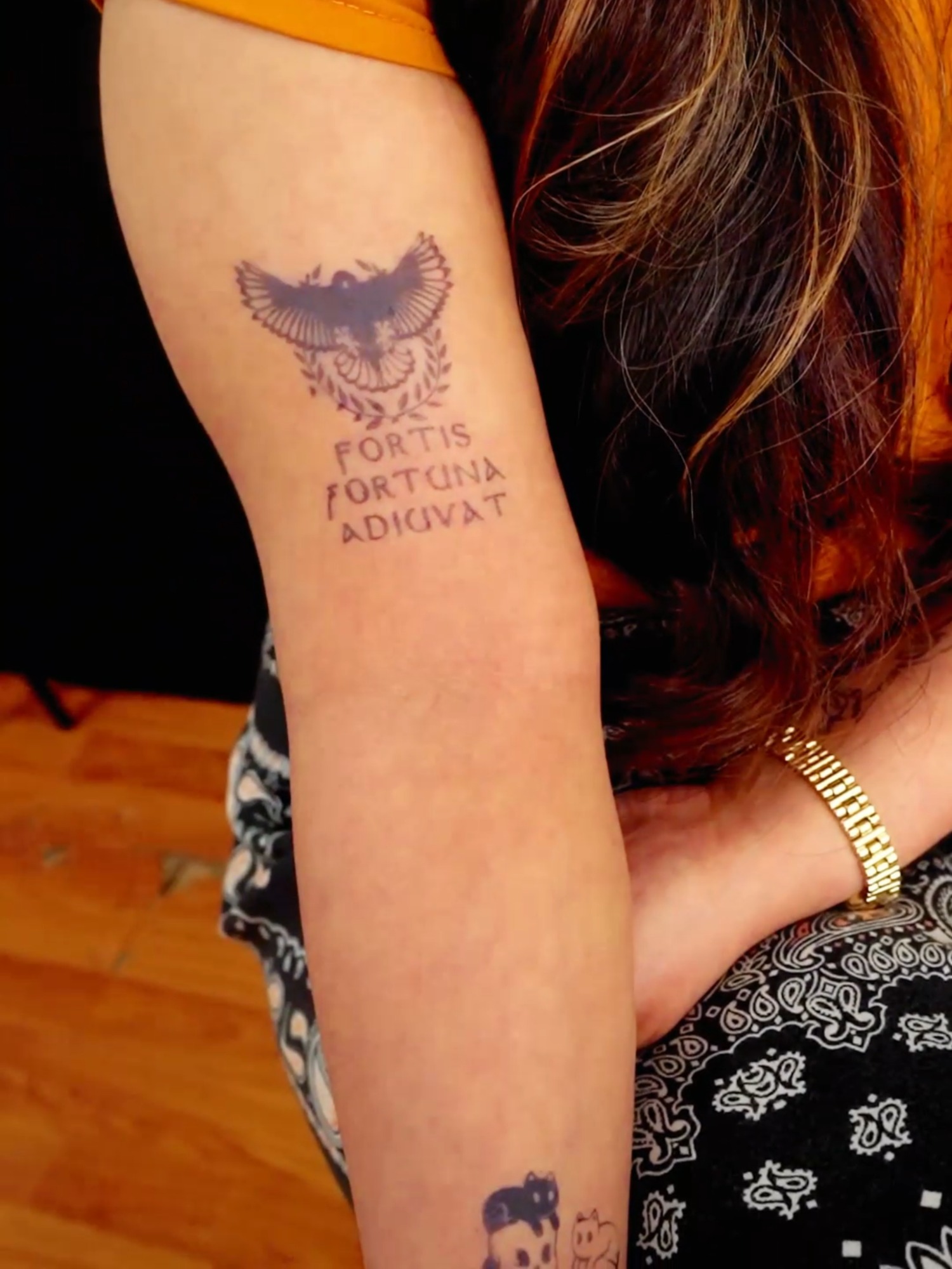 Small Emblemed Arm Tattoo