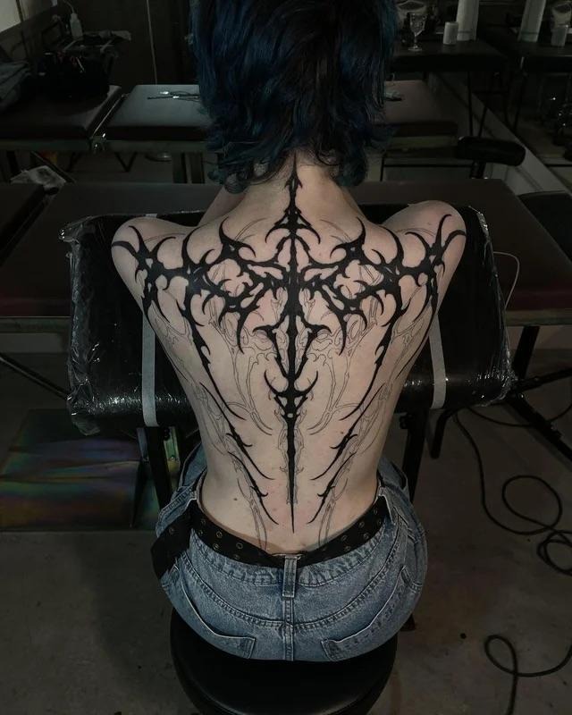 Bold Ornamental Blackwork Spine Tattoo
