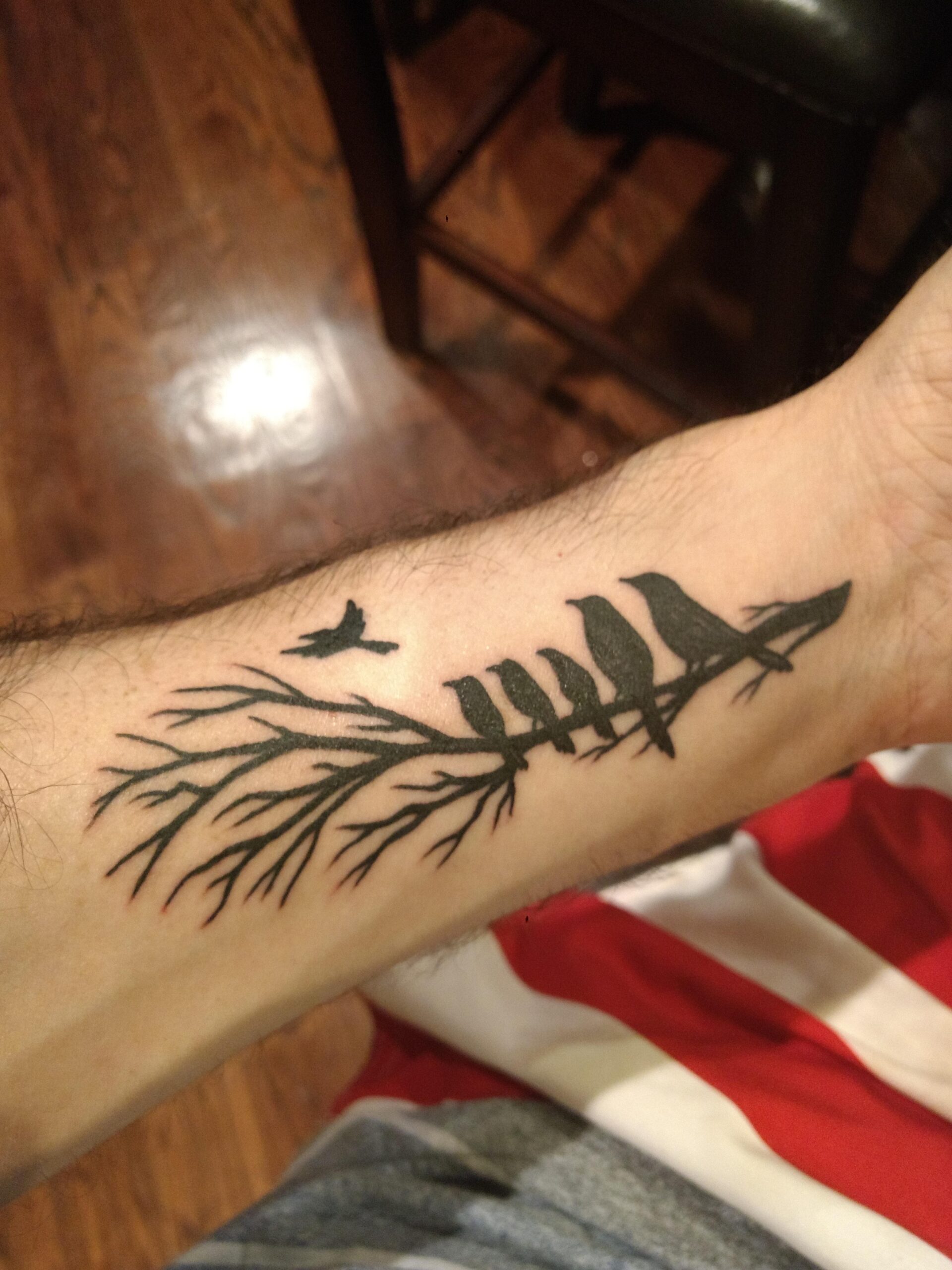 Forest-inspired bird tattoo design