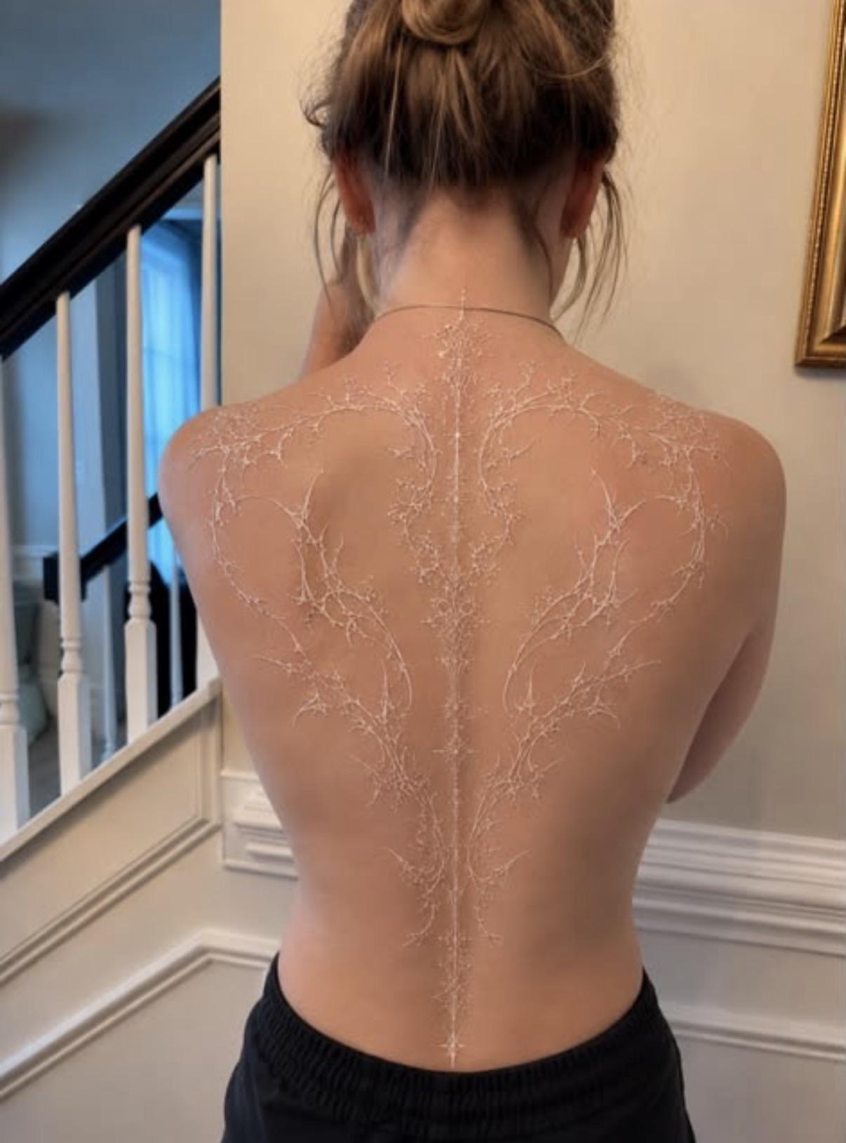 Elegant White Ink Spinal Outline Tattoo
