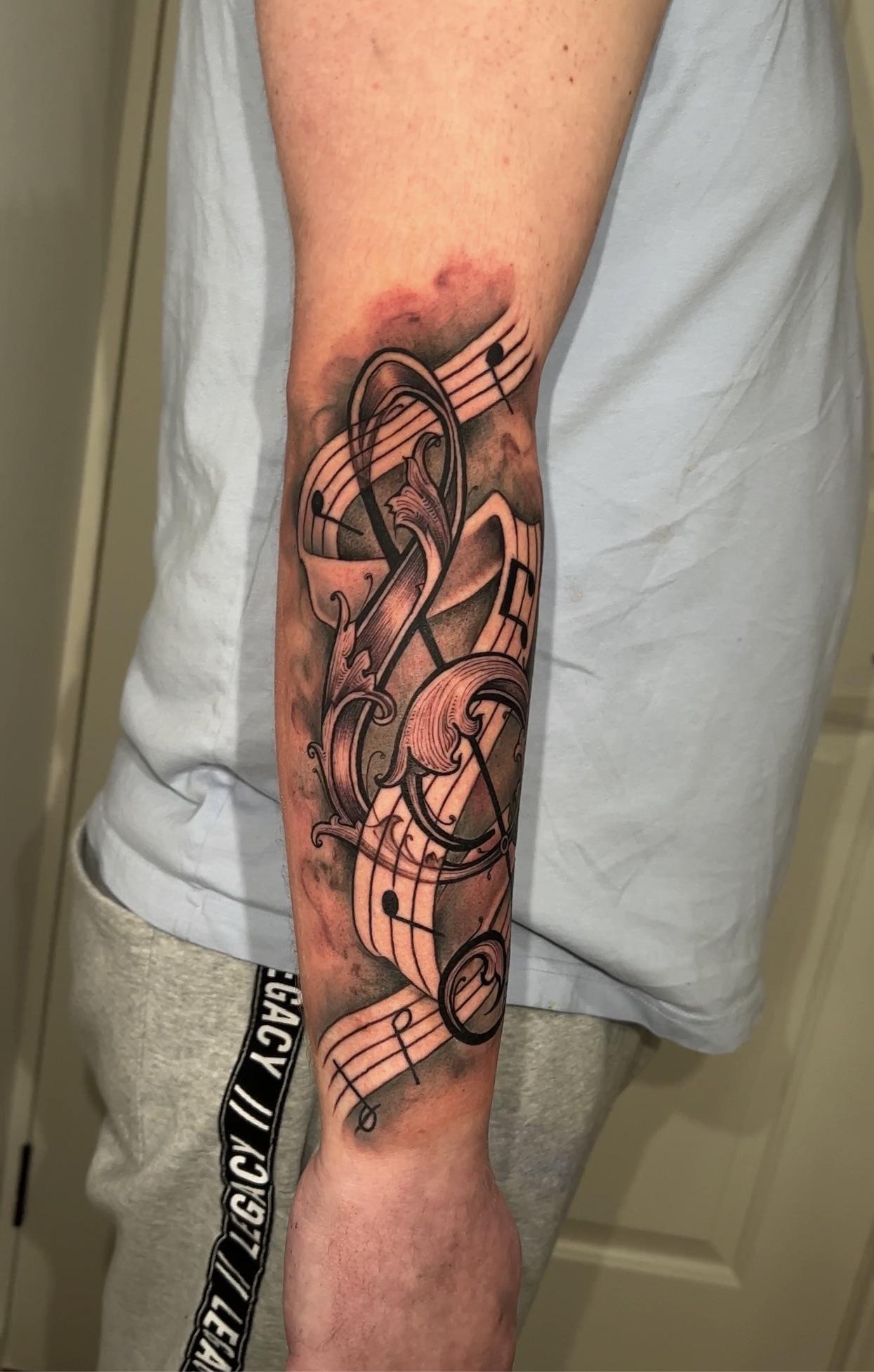 Artistic Musical Notes and G-Clef Tattoo