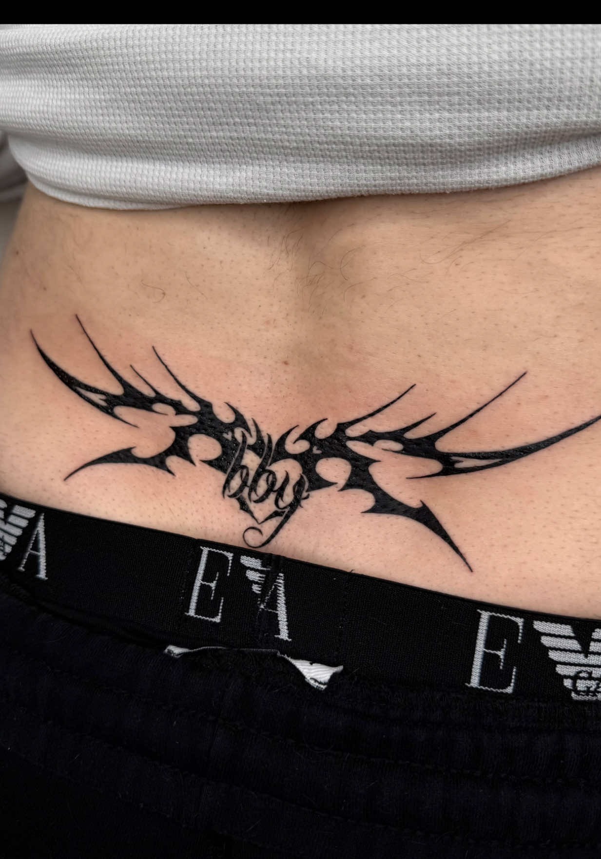 Modern y2k style lower back tattoo