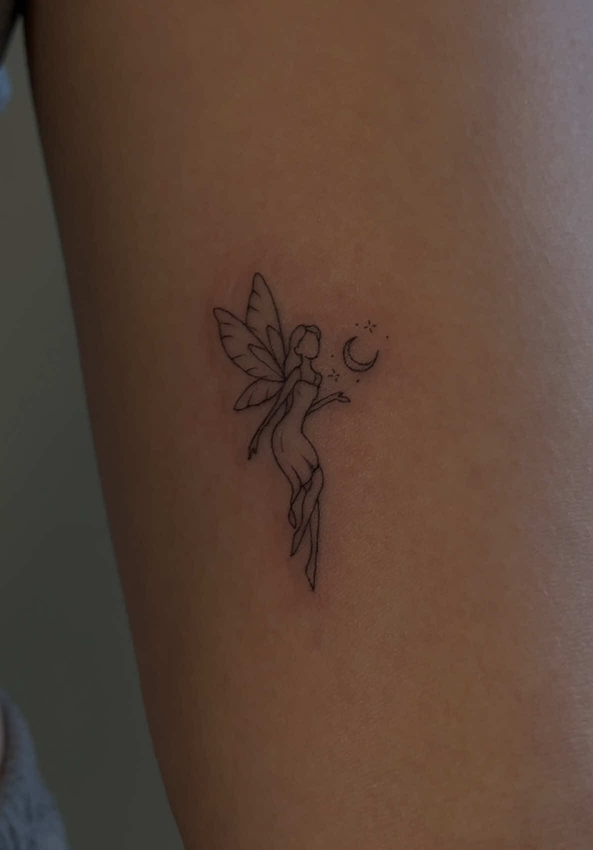Whimsical Fine-Line Fairy Tattoo
