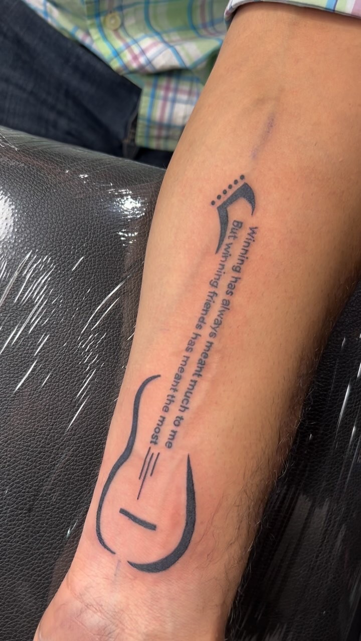 Minimalist Guitar Lyric Tattoo