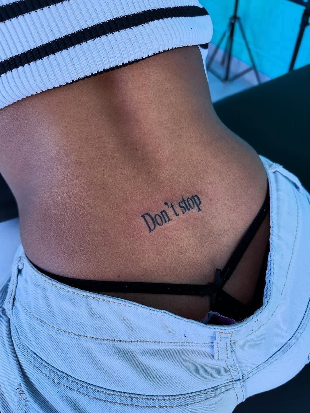 Minimalist Script Lower Back Tattoo